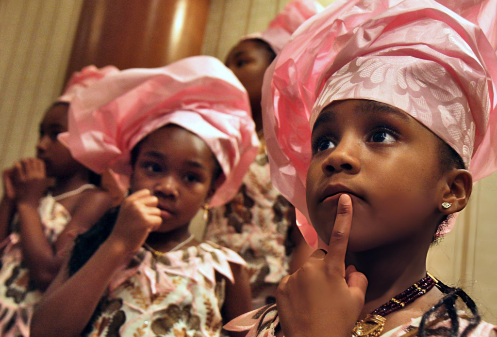 Nigerian children in traditional cultural attire — joyful and natural, showing cultural dress as part of everyday life