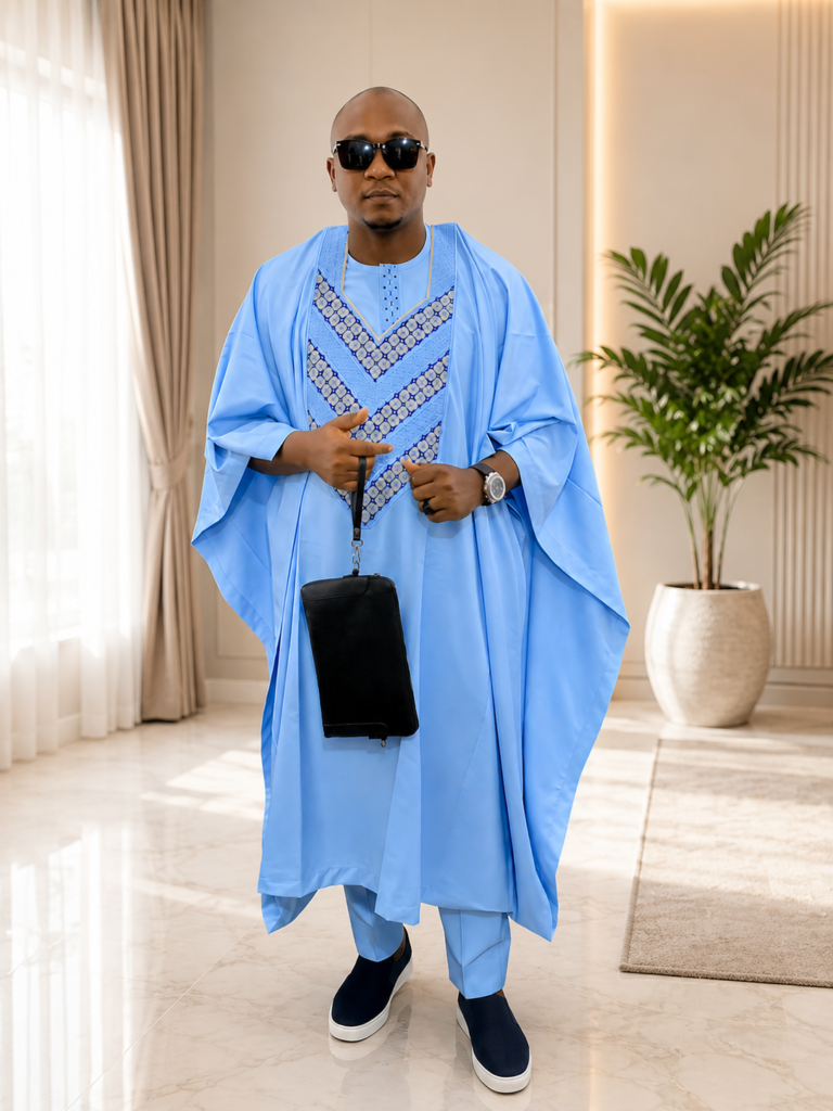 Premium sky-blue Agbada with bold V-shaped embroidery in darker blue and gold tones — new design by Ola & Vick, Ilorin Nigeria